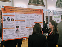 photo of grad student melanie standing by her poster
