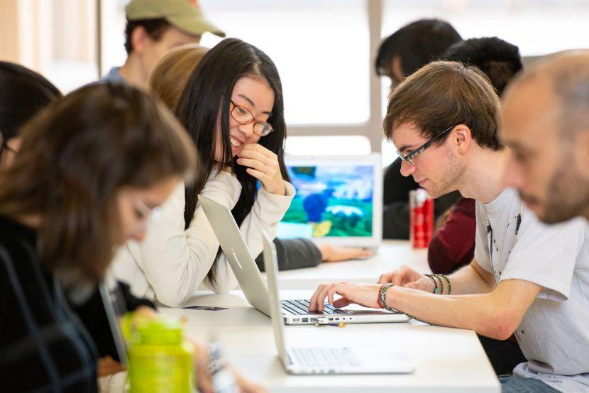 9 students sitting at a table