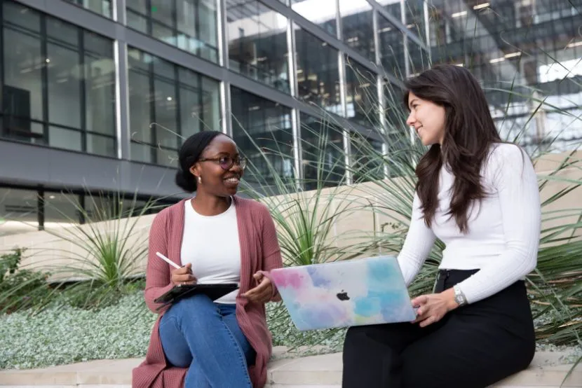 Two students talking on UT campus