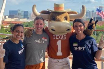 BEVO mascot with three students smiling