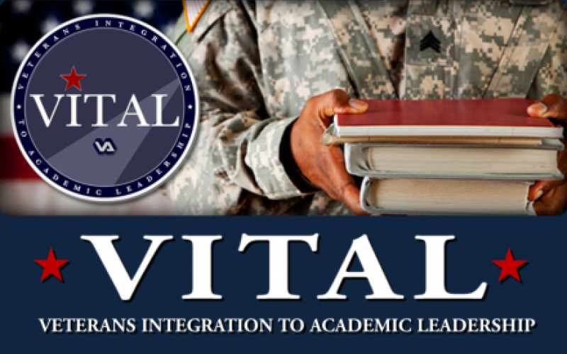 vital veteran holding books